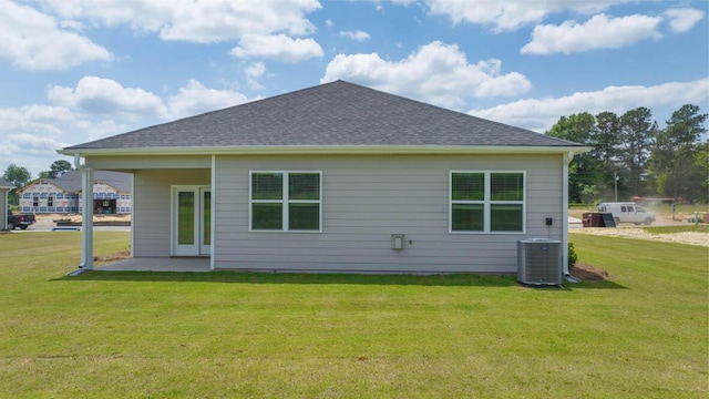 back of house featuring a patio, a yard, and central AC