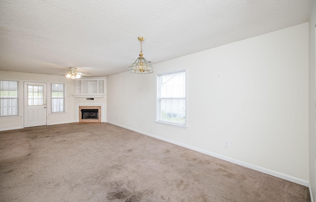 107 Barts Dr, Augusta, GA 30909 - unfurnished living room with carpet, baseboards, a fireplace, a textured ceiling, and a chandelier