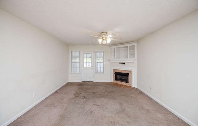 107 Barts Dr, Augusta, GA 30909 - unfurnished living room featuring a fireplace with raised hearth, carpet floors, a ceiling fan, baseboards, and a textured ceiling