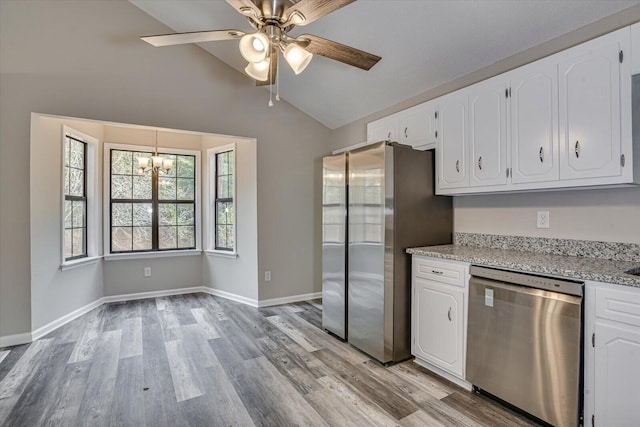 kitchen with white cabinetry, ceiling fan with notable chandelier, stainless steel appliances, and vaulted ceiling