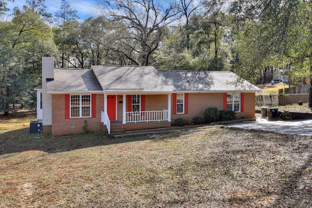 ranch-style home with covered porch and a front yard