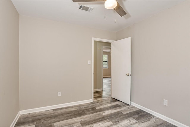 spare room with ceiling fan and hardwood / wood-style floors