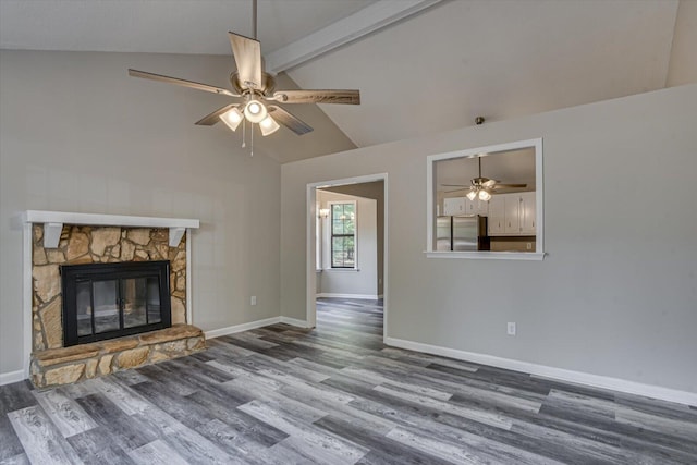 unfurnished living room with vaulted ceiling with beams, ceiling fan, a fireplace, and dark wood-type flooring