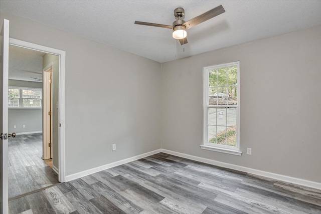 spare room with ceiling fan, hardwood / wood-style floors, and a textured ceiling