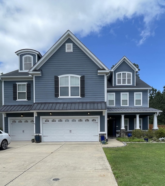 703 Burch Creek Dr, Grovetown, GA 30813 - view of front facade with a standing seam roof, driveway, a front lawn, and an attached garage