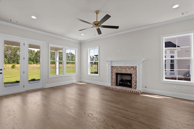 unfurnished living room with wood finished floors, healthy amount of natural light, baseboards, ornamental molding, and recessed lighting