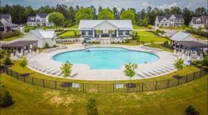 community pool with a residential view and a patio area