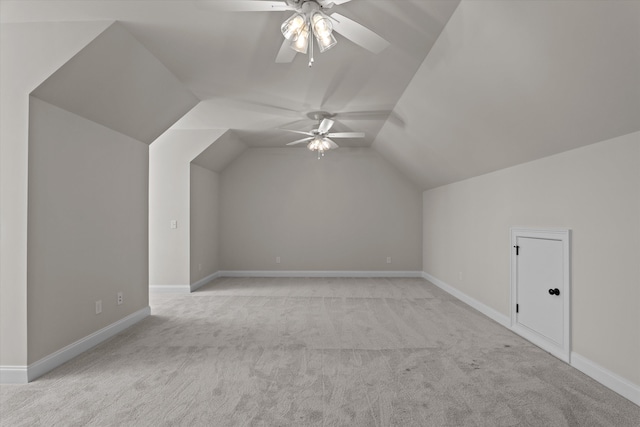 bonus room featuring light carpet, a ceiling fan, vaulted ceiling, and baseboards