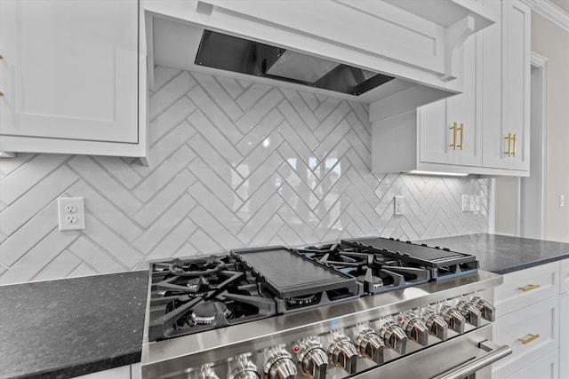 kitchen featuring stainless steel range, custom range hood, backsplash, and white cabinetry