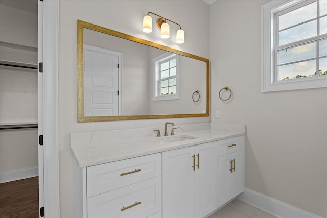 bathroom with baseboards and vanity