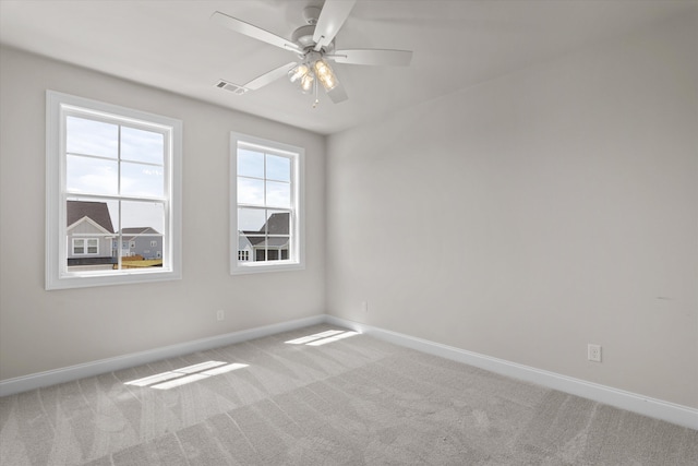 spare room with carpet floors, baseboards, and ceiling fan