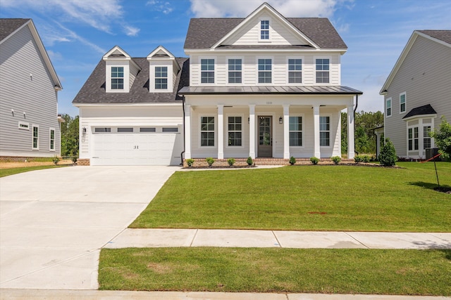 view of front of home with roof with shingles, covered porch, concrete driveway, and a front yard