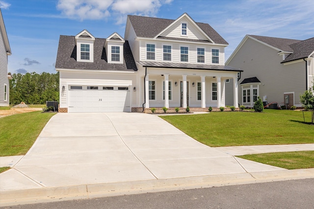 view of front facade with a porch, concrete driveway, a standing seam roof, a shingled roof, and a front lawn