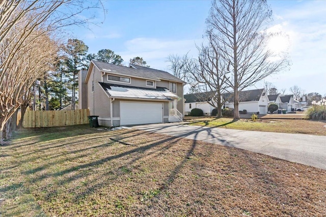 view of front of house with a garage and a front lawn