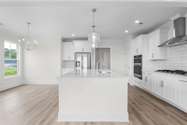309 Militia Loop, North Augusta, SC 29860 - kitchen with stainless steel appliances, a sink, wall chimney exhaust hood, decorative backsplash, and a center island with sink