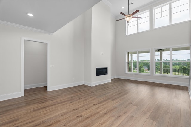 309 Militia Loop, North Augusta, SC 29860 - unfurnished living room with ornamental molding, a ceiling fan, wood finished floors, baseboards, and healthy amount of natural light