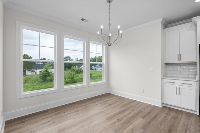 309 Militia Loop, North Augusta, SC 29860 - unfurnished dining area featuring ornamental molding, light wood-style flooring, baseboards, and a chandelier