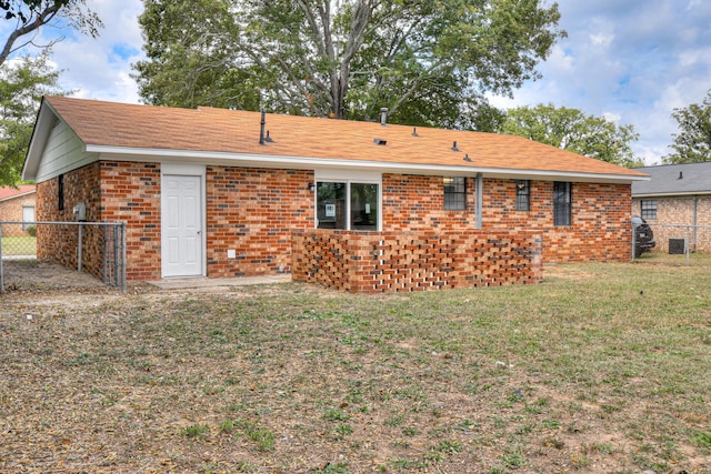 back of house with a yard and cooling unit