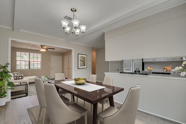 dining area with light hardwood / wood-style flooring and ceiling fan with notable chandelier