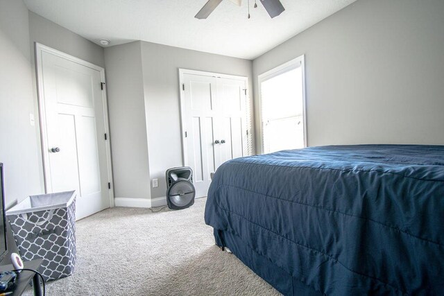 carpeted bedroom featuring ceiling fan