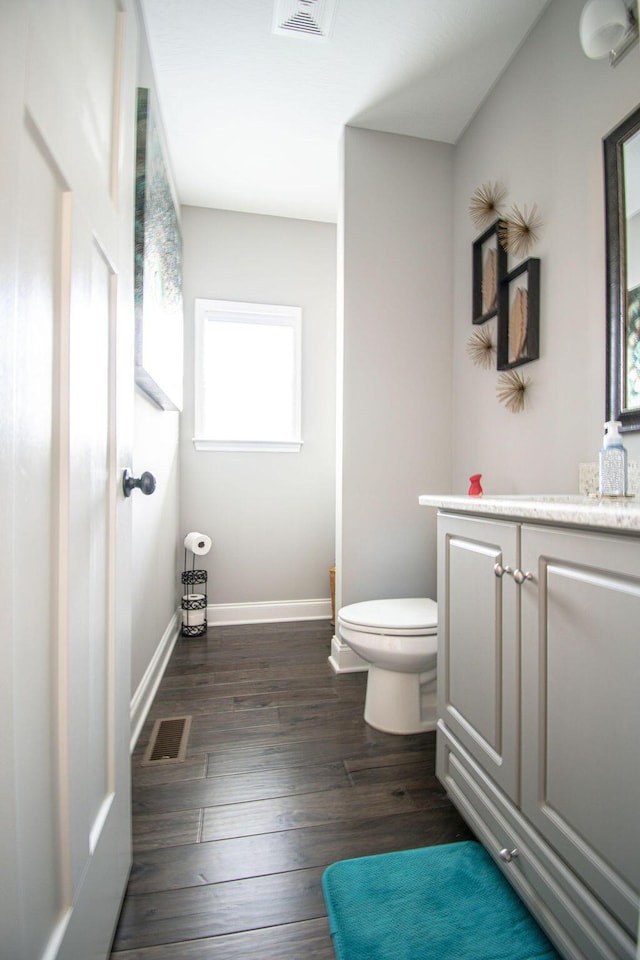 bathroom featuring hardwood / wood-style floors, vanity, and toilet