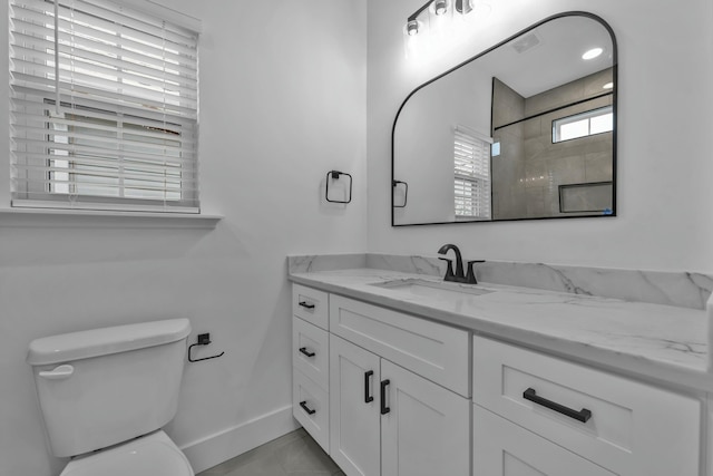 bathroom featuring toilet, visible vents, vanity, and baseboards