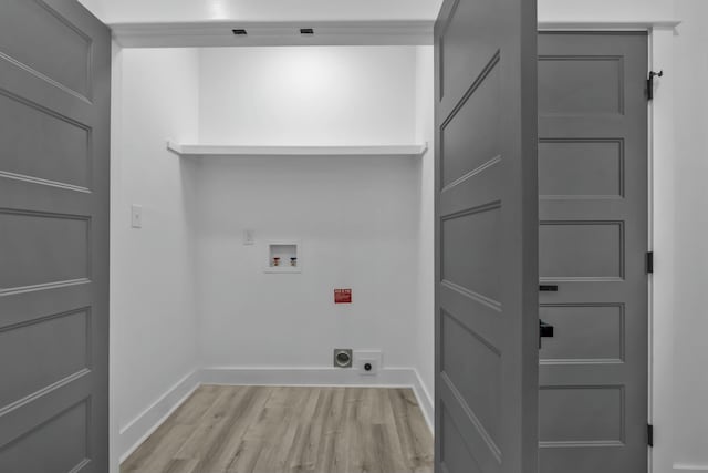 clothes washing area featuring hookup for a washing machine, light wood-style floors, electric dryer hookup, laundry area, and baseboards