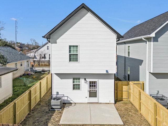 back of house with a patio, a fenced backyard, and central air condition unit