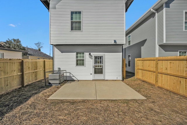 back of house with central AC, a patio area, and a fenced backyard