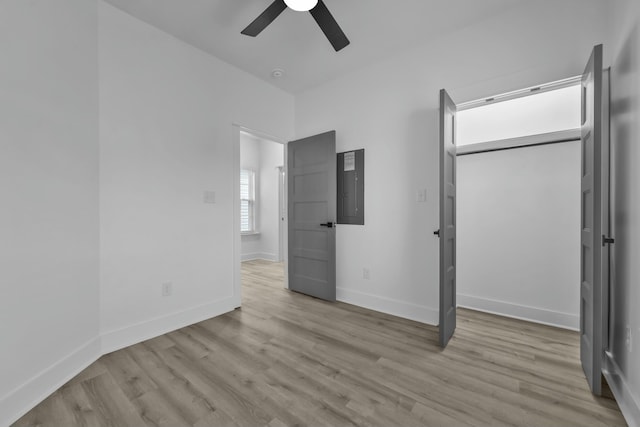 unfurnished bedroom featuring light wood finished floors, ceiling fan, and baseboards