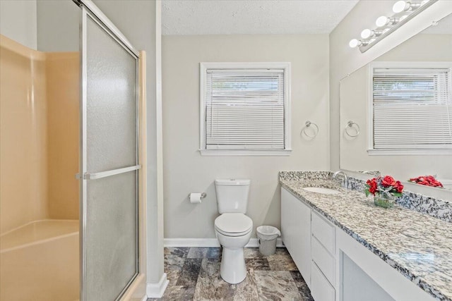 full bath with vanity, toilet, a textured ceiling, baseboards, and a shower stall