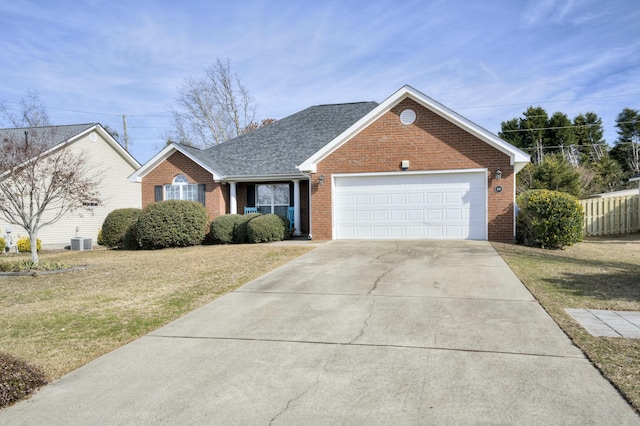 ranch-style house featuring a garage, cooling unit, and a front lawn