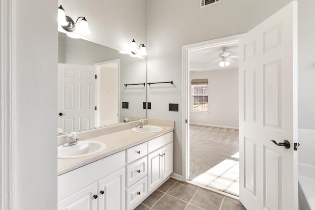 bathroom with tile patterned flooring, double vanity, a bathtub, and a sink