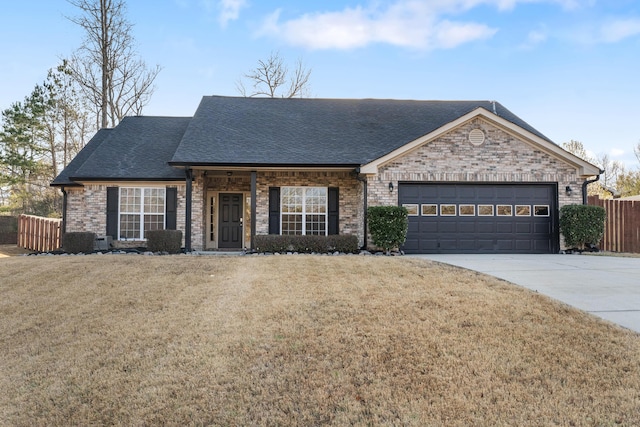 view of front of home featuring an attached garage, roof with shingles, a front lawn, and fence