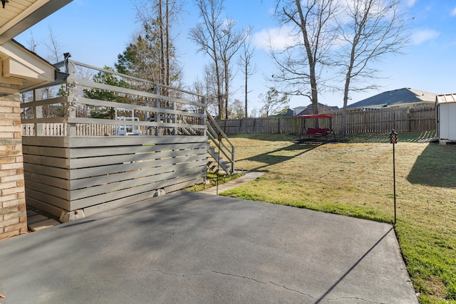 view of yard with a storage unit, an outdoor structure, a fenced backyard, and a patio area