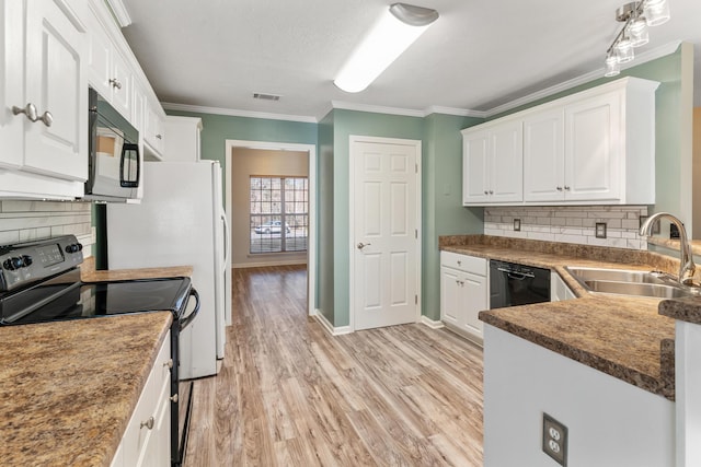 kitchen with visible vents, black appliances, a sink, white cabinetry, and crown molding