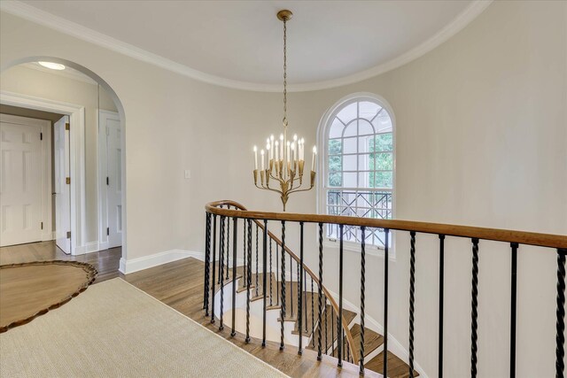 3406 W Richland Ave, Aiken, SC 29801 - hall featuring wood finished floors, arched walkways, ornamental molding, a chandelier, and an upstairs landing