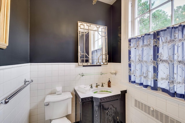 3406 W Richland Ave, Aiken, SC 29801 - bathroom with vanity, tile walls, wainscoting, and radiator