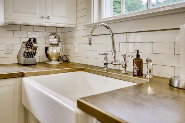 3406 W Richland Ave, Aiken, SC 29801 - kitchen view of tasteful backsplash, white cabinetry, and butcher block countertops