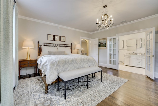 3406 W Richland Ave, Aiken, SC 29801 - bedroom with ornamental molding, wood finished floors, a chandelier, french doors, and ensuite bath