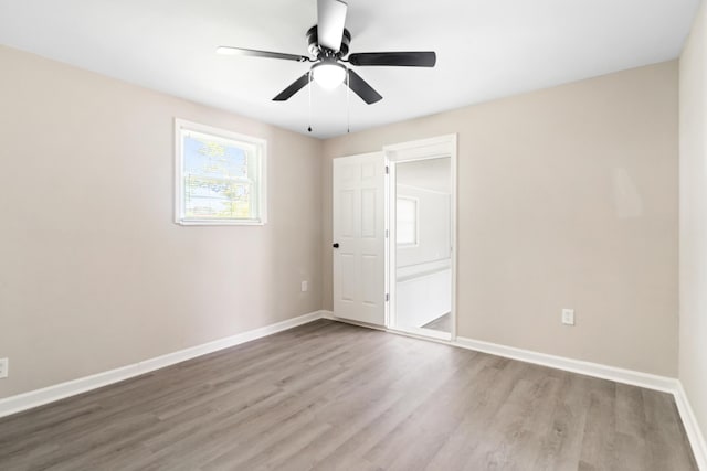 unfurnished bedroom with baseboards, a ceiling fan, and wood finished floors
