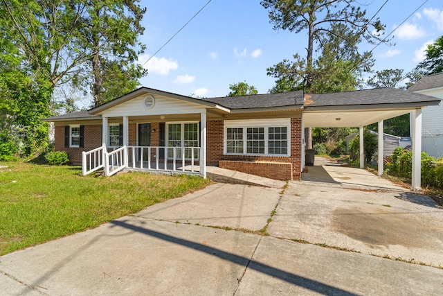 view of front facade featuring covered porch, driveway, a front lawn, and brick siding