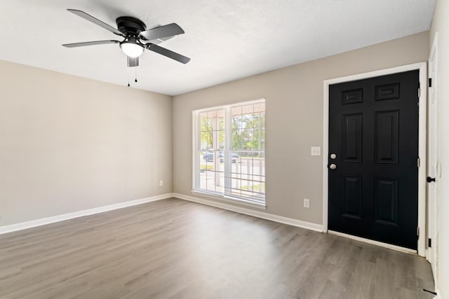 entrance foyer featuring wood finished floors, baseboards, and a ceiling fan