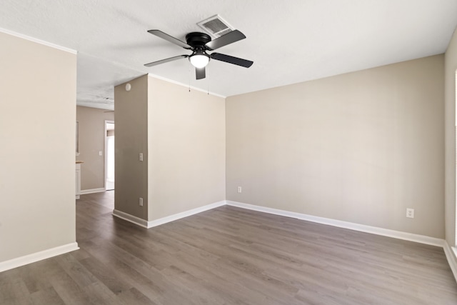 unfurnished room featuring baseboards, a ceiling fan, and wood finished floors
