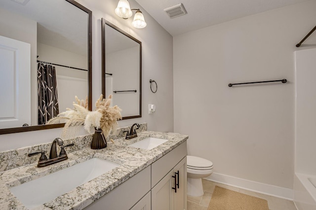 bathroom with tile patterned floors, vanity, toilet, and walk in shower