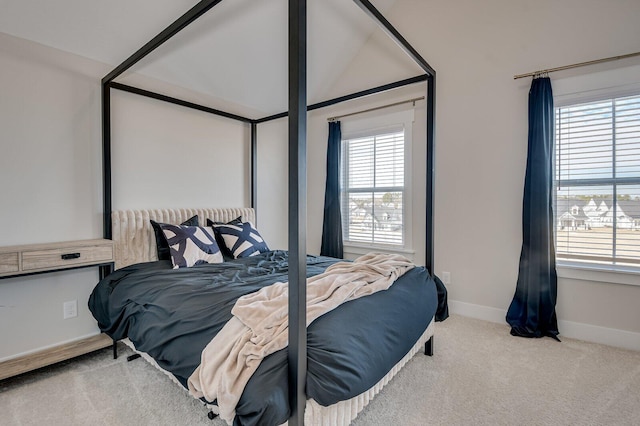 carpeted bedroom featuring lofted ceiling