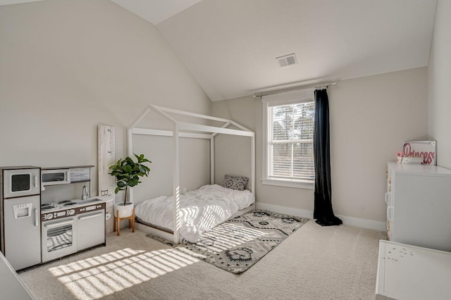 bedroom featuring lofted ceiling and light carpet