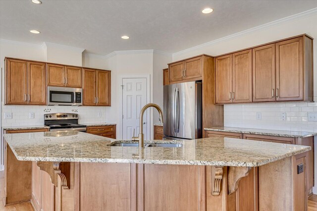 kitchen with tasteful backsplash, a sink, freestanding refrigerator, light wood finished floors, and crown molding