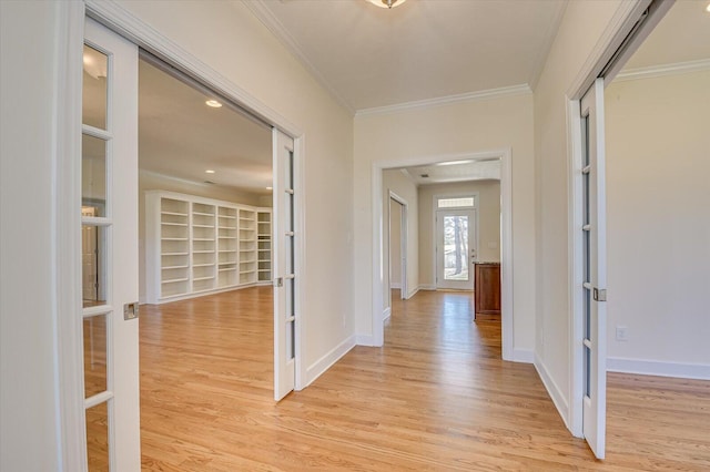 hall featuring crown molding, french doors, baseboards, and light wood-style floors