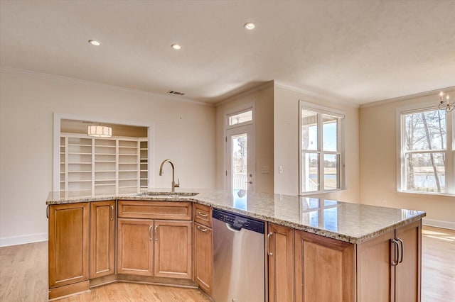 kitchen with dishwasher, light stone countertops, light wood-type flooring, and a sink